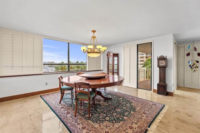 1 Grove Isle Dr Unit A409, Miami, FL 33133 - dining room with a chandelier and baseboards