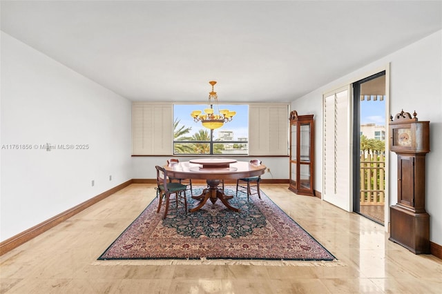 1 Grove Isle Dr Unit A409, Miami, FL 33133 - dining room with a chandelier and baseboards