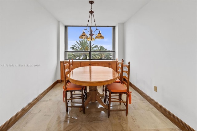 1 Grove Isle Dr Unit A409, Miami, FL 33133 - dining room with a chandelier and baseboards