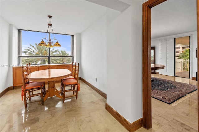 1 Grove Isle Dr Unit A409, Miami, FL 33133 - dining room featuring baseboards, a chandelier, and plenty of natural light