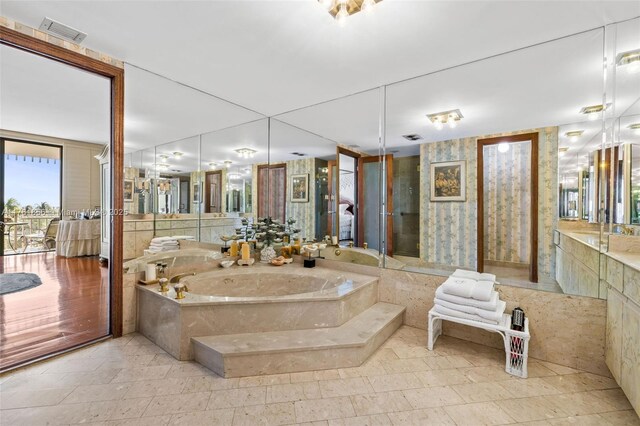 1 Grove Isle Dr Unit A409, Miami, FL 33133 - bathroom featuring a garden tub and vanity