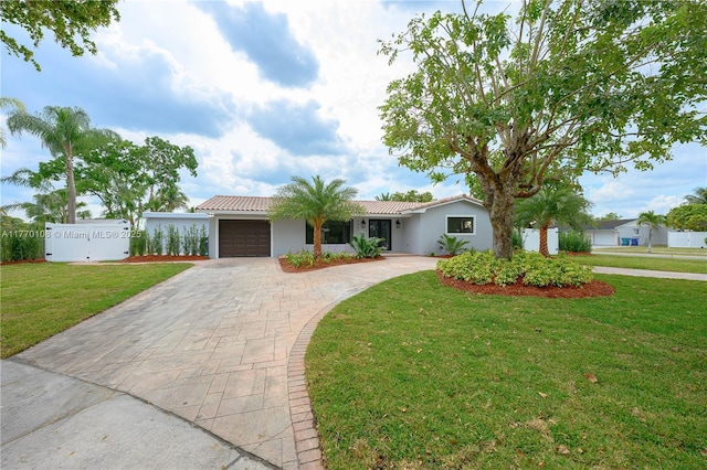 single story home with a tile roof, stucco siding, an attached garage, decorative driveway, and a front yard