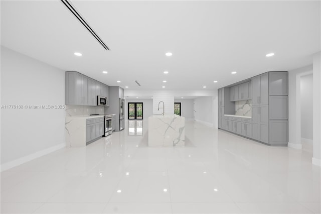 unfurnished living room with baseboards and recessed lighting