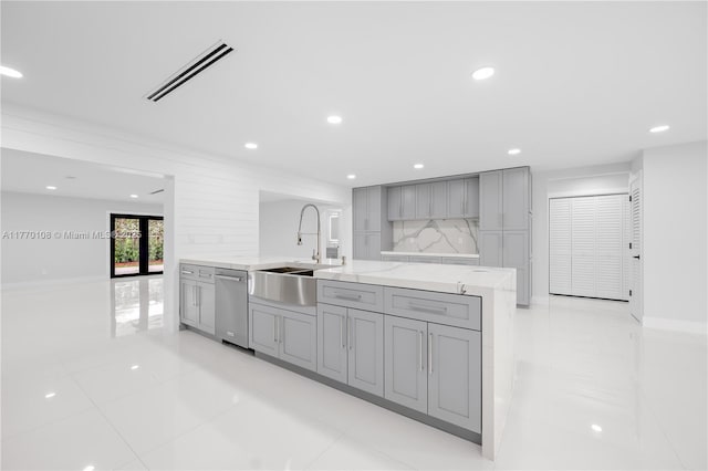 kitchen with recessed lighting, a sink, gray cabinetry, and visible vents