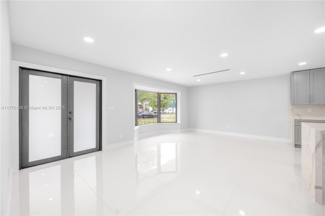 unfurnished room with light tile patterned floors, baseboards, and recessed lighting