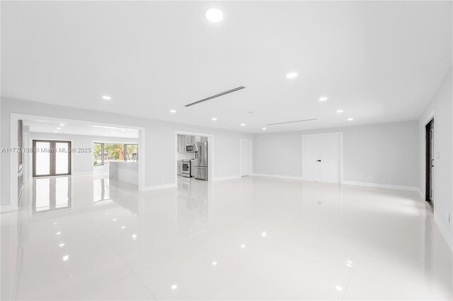 empty room with baseboards and recessed lighting