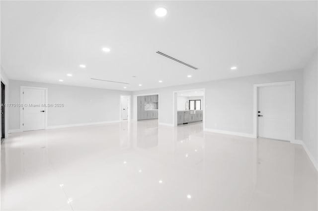 empty room featuring baseboards and recessed lighting