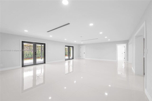 spare room featuring baseboards, visible vents, french doors, and recessed lighting