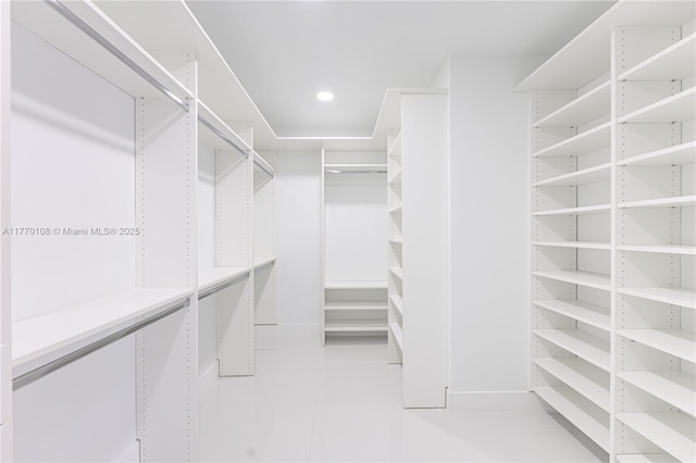 walk in closet with light tile patterned flooring