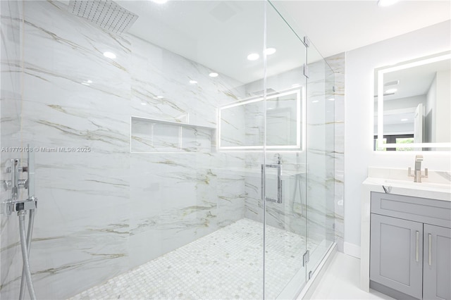 full bathroom with vanity and a marble finish shower