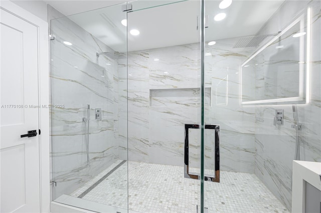 bathroom featuring recessed lighting and a marble finish shower
