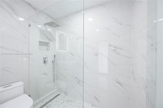 bathroom with a marble finish shower and toilet