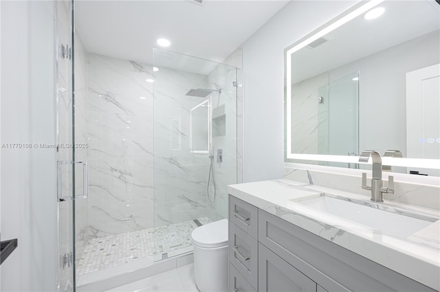 full bathroom with recessed lighting, toilet, vanity, and a marble finish shower