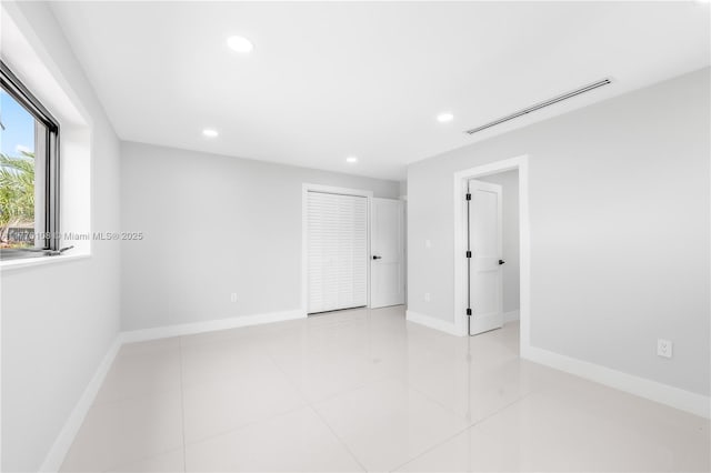 unfurnished room featuring baseboards, visible vents, recessed lighting, and light tile patterned floors
