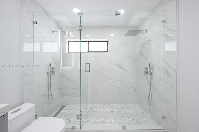 full bathroom with a marble finish shower, toilet, and vanity