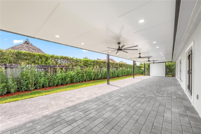view of patio with a fenced backyard and a ceiling fan