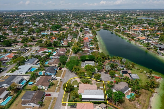 drone / aerial view with a residential view and a water view