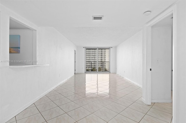 9273 Collins Ave Unit 607, Surfside, FL 33154 - tiled spare room with baseboards, visible vents, and floor to ceiling windows