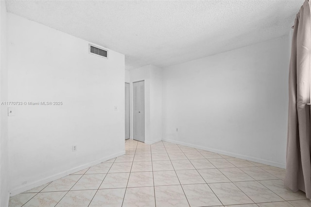 9273 Collins Ave Unit 607, Surfside, FL 33154 - empty room featuring a textured ceiling, baseboards, and visible vents
