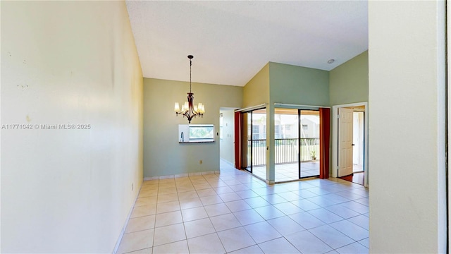 1140 Independence Trl Unit 1140-D, Homestead, FL 33034 - unfurnished room featuring light tile patterned flooring, vaulted ceiling, and an inviting chandelier