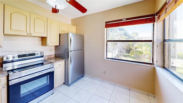 1140 Independence Trl Unit 1140-D, Homestead, FL 33034 - kitchen with light tile patterned floors, stainless steel appliances, a textured ceiling, cream cabinets, and a ceiling fan