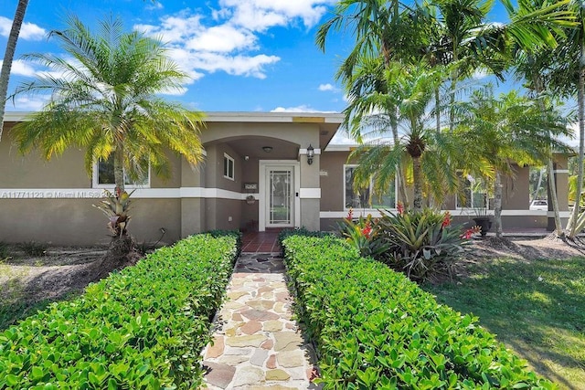 8480 Caribbean Blvd, Cutler Bay, FL 33157 - doorway to property featuring stucco siding and fence