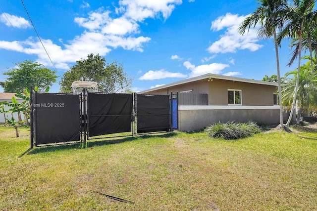 8480 Caribbean Blvd, Cutler Bay, FL 33157 - exterior space featuring a yard, a gate, stucco siding, and fence