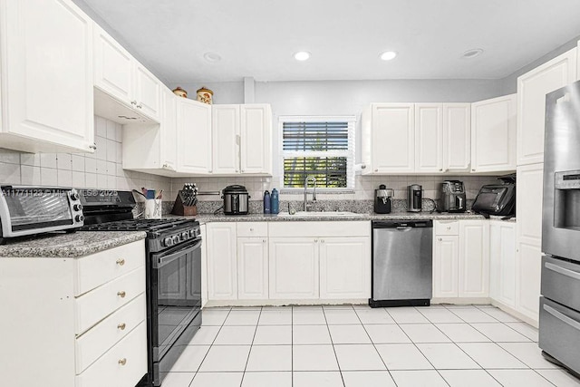 8480 Caribbean Blvd, Cutler Bay, FL 33157 - kitchen with white cabinetry, a sink, appliances with stainless steel finishes, and decorative backsplash