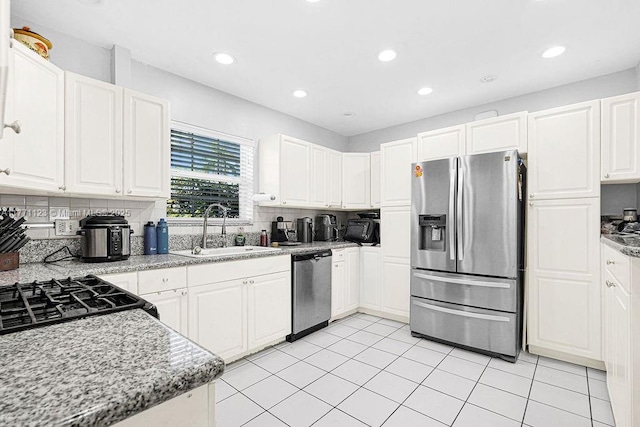 8480 Caribbean Blvd, Cutler Bay, FL 33157 - kitchen with a sink, white cabinetry, tasteful backsplash, and appliances with stainless steel finishes