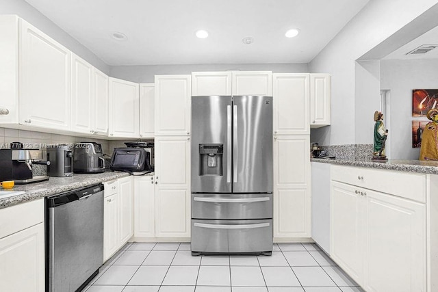 8480 Caribbean Blvd, Cutler Bay, FL 33157 - kitchen featuring white cabinetry, light tile patterned floors, decorative backsplash, visible vents, and appliances with stainless steel finishes