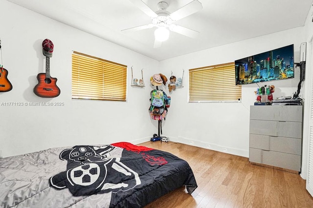 8480 Caribbean Blvd, Cutler Bay, FL 33157 - bedroom with baseboards, wood finished floors, and a ceiling fan