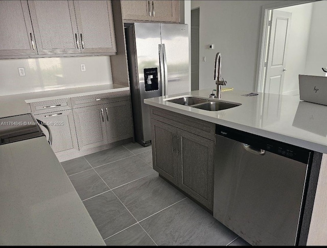 kitchen with light countertops, a sink, and stainless steel appliances