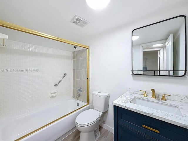 full bath featuring bathtub / shower combination, toilet, vanity, wood finished floors, and visible vents