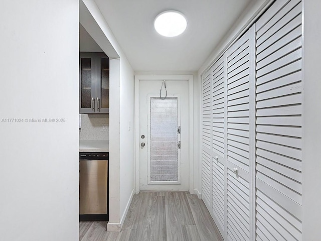 entryway with baseboards and light wood-style floors
