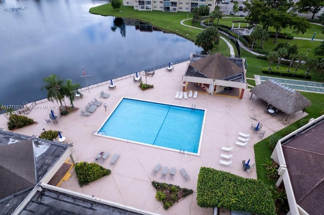 view of swimming pool featuring a water view and a patio