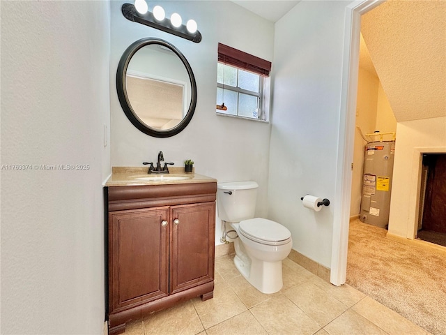 bathroom featuring vanity, toilet, baseboards, tile patterned floors, and electric water heater