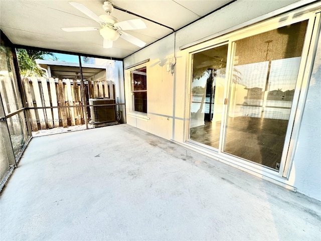 unfurnished sunroom with ceiling fan