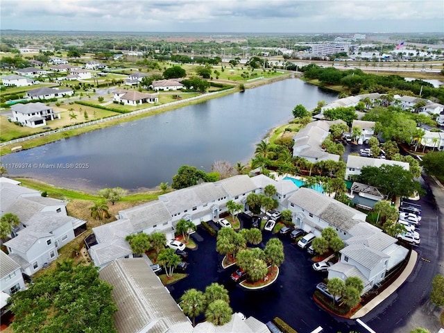 drone / aerial view featuring a residential view and a water view
