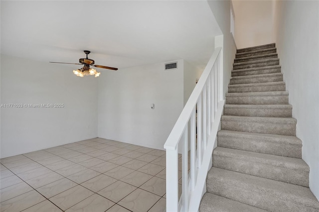 staircase with visible vents and a ceiling fan