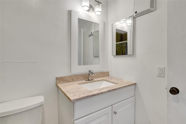 bathroom featuring toilet and vanity