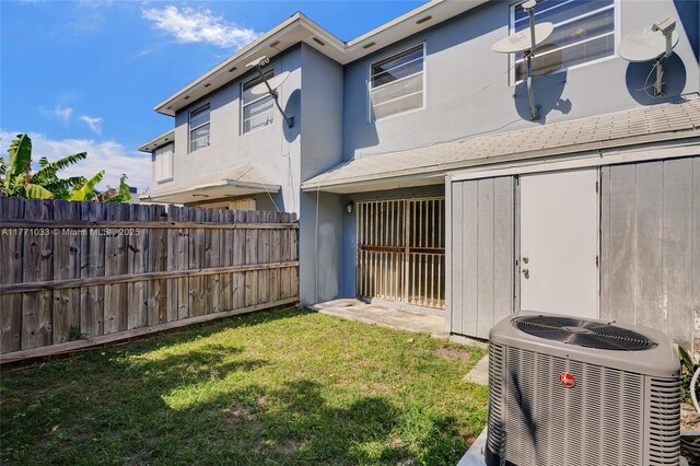exterior space with central AC unit and fence