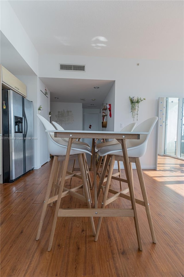 dining room featuring visible vents and wood finished floors
