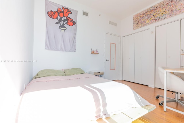 bedroom with visible vents and light wood-style floors