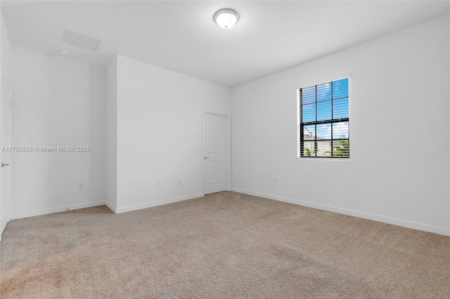 carpeted empty room with baseboards