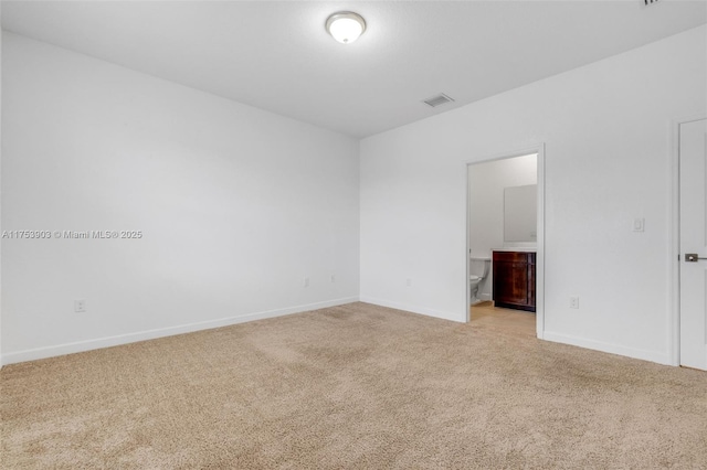 empty room featuring light carpet, baseboards, and visible vents