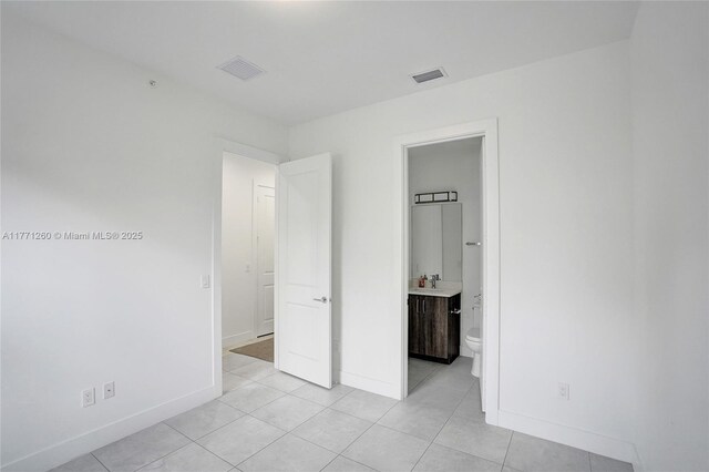 63 NW 4th Ave, Delray Beach, FL 33444 - unfurnished bedroom featuring baseboards, visible vents, and light tile patterned floors