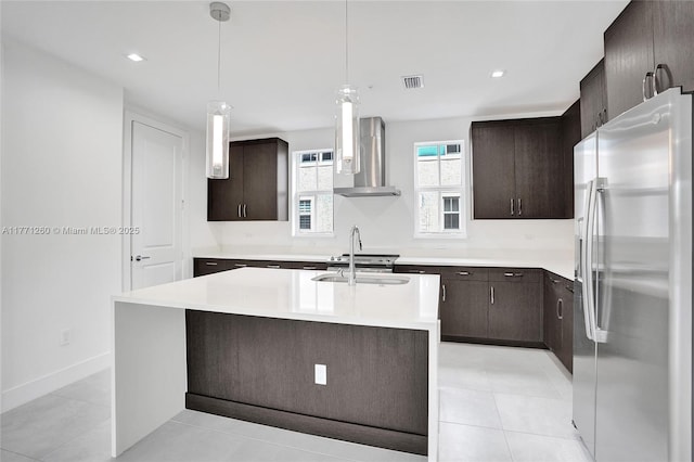63 NW 4th Ave, Delray Beach, FL 33444 - kitchen with stainless steel fridge, a sink, visible vents, dark brown cabinets, and wall chimney exhaust hood
