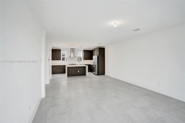 63 NW 4th Ave, Delray Beach, FL 33444 - unfurnished living room with baseboards, a sink, and recessed lighting