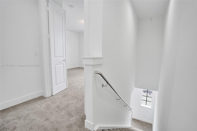 63 NW 4th Ave, Delray Beach, FL 33444 - hallway with baseboards, an upstairs landing, and carpet flooring
