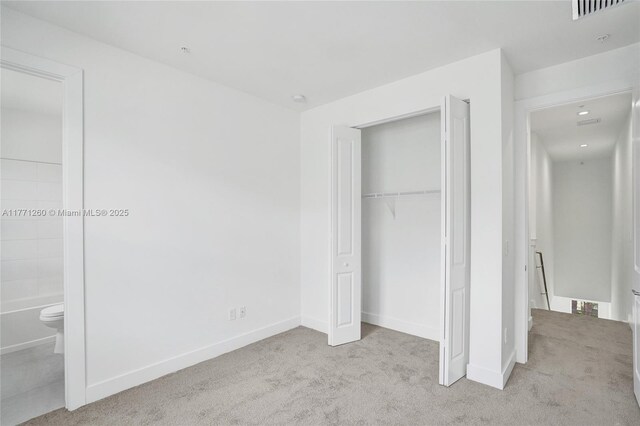 63 NW 4th Ave, Delray Beach, FL 33444 - unfurnished bedroom featuring carpet flooring, baseboards, a closet, and visible vents